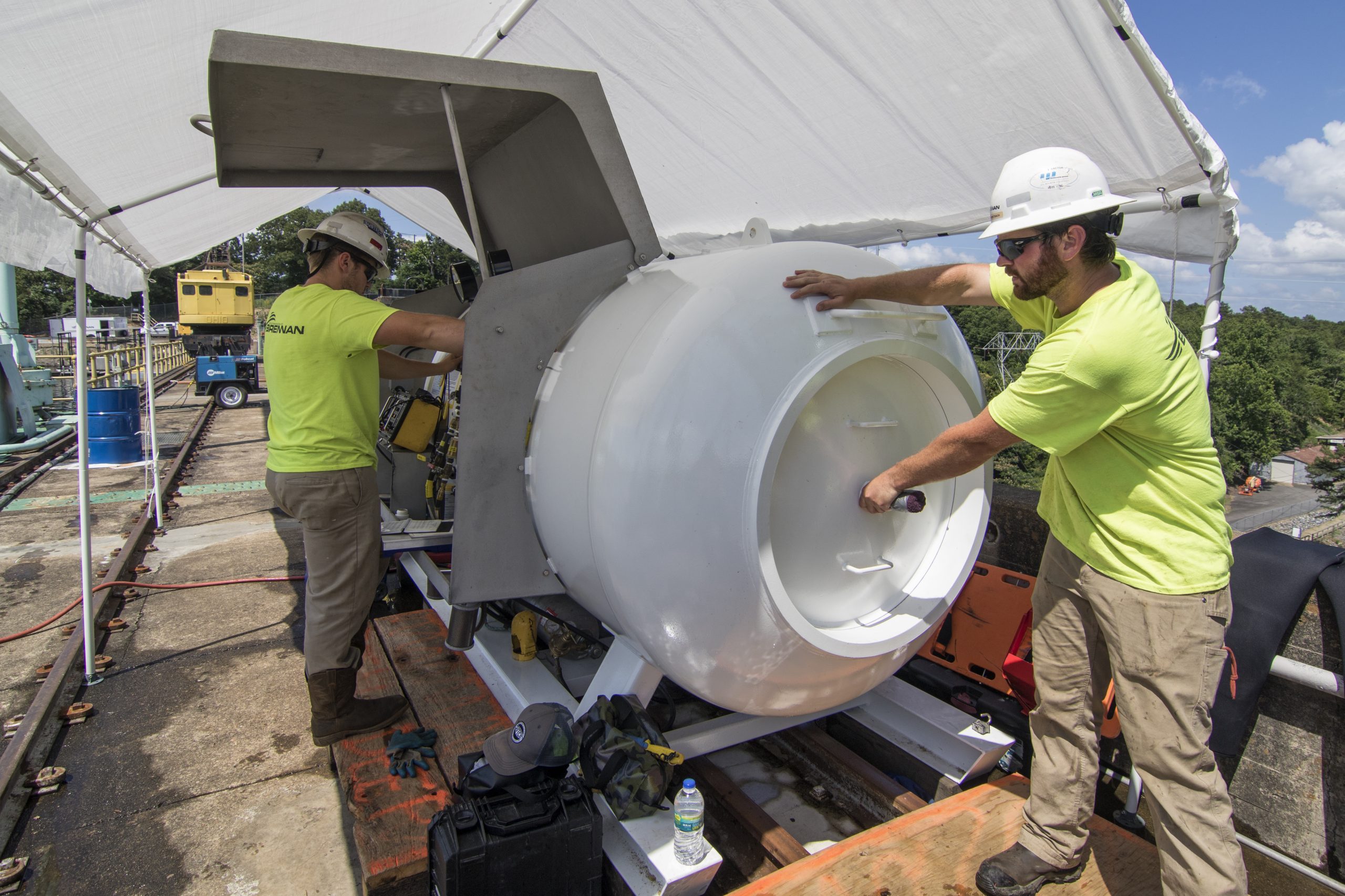 Brennan divers make adjustments to a decompression chamber