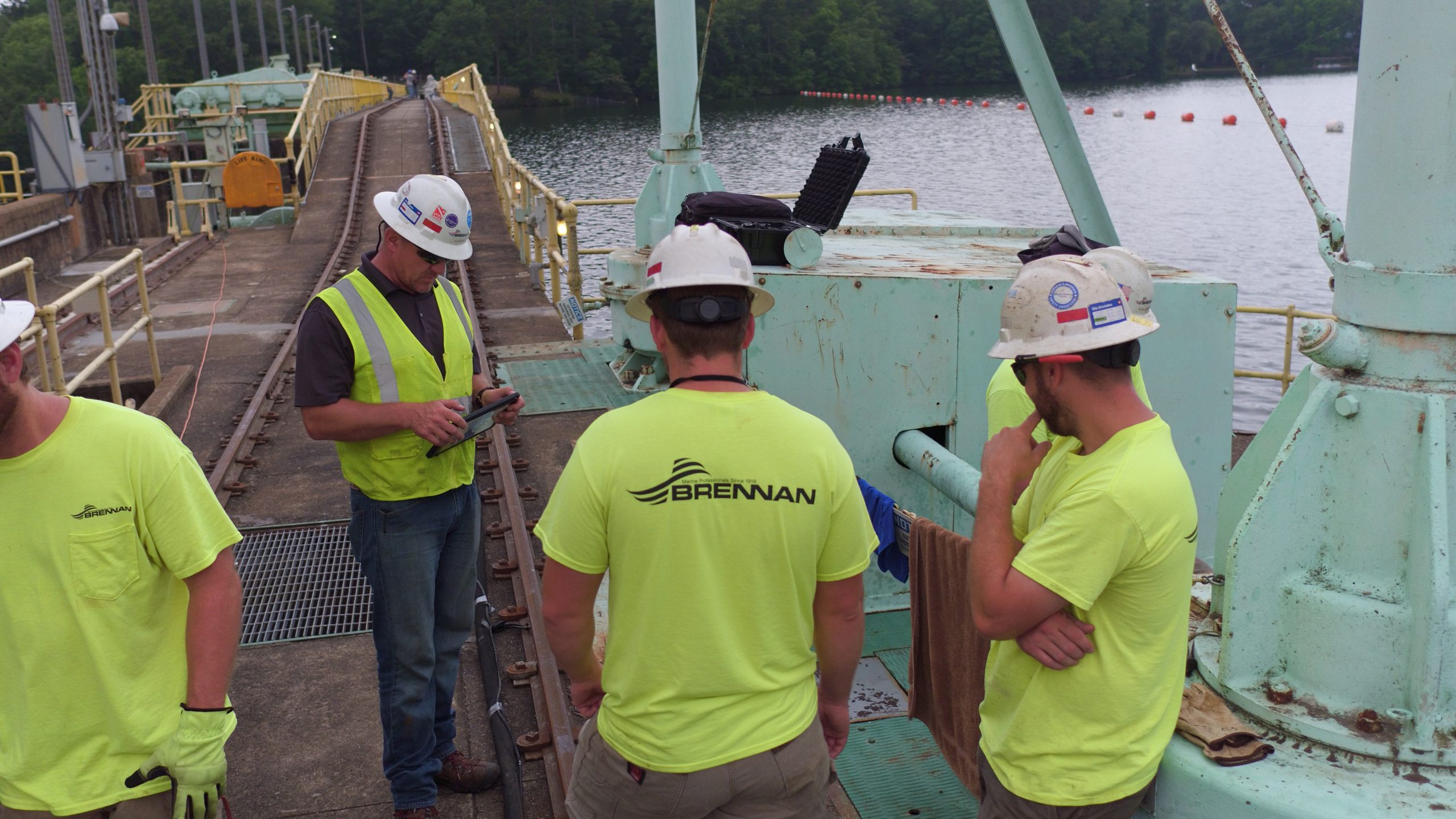 Brennan employees conduct a meeting discussing work and safety responsibilities