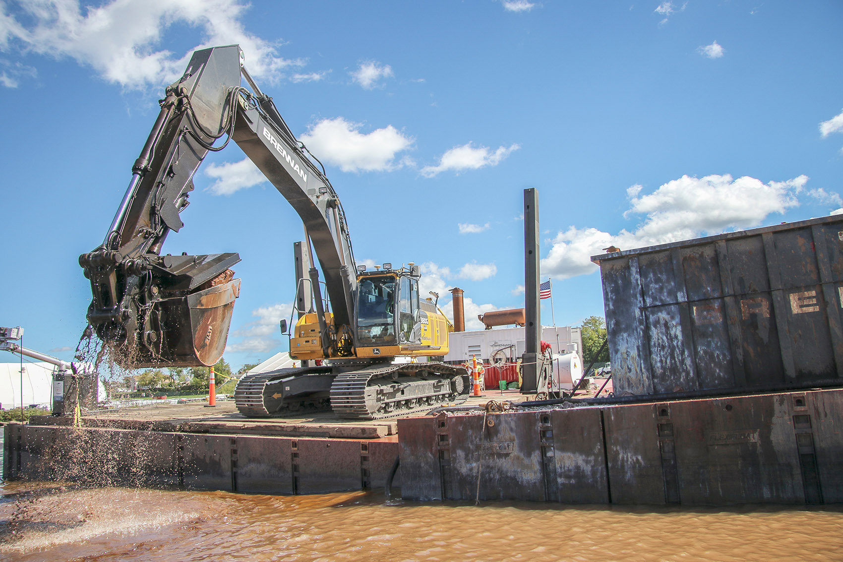 Brennan moving mechanically dredged material into a material barge 